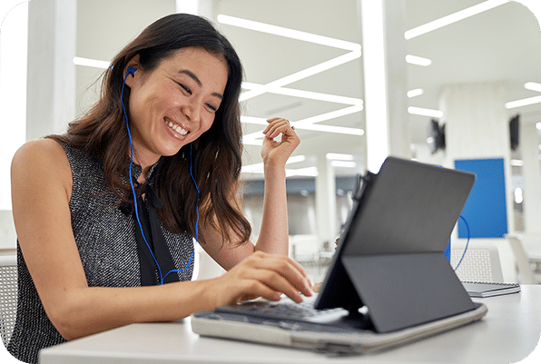 smiling woman with ear phones i from of laptop