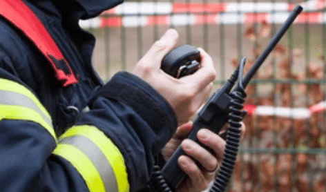 Emergency Responder on Talking on handheld Radio.